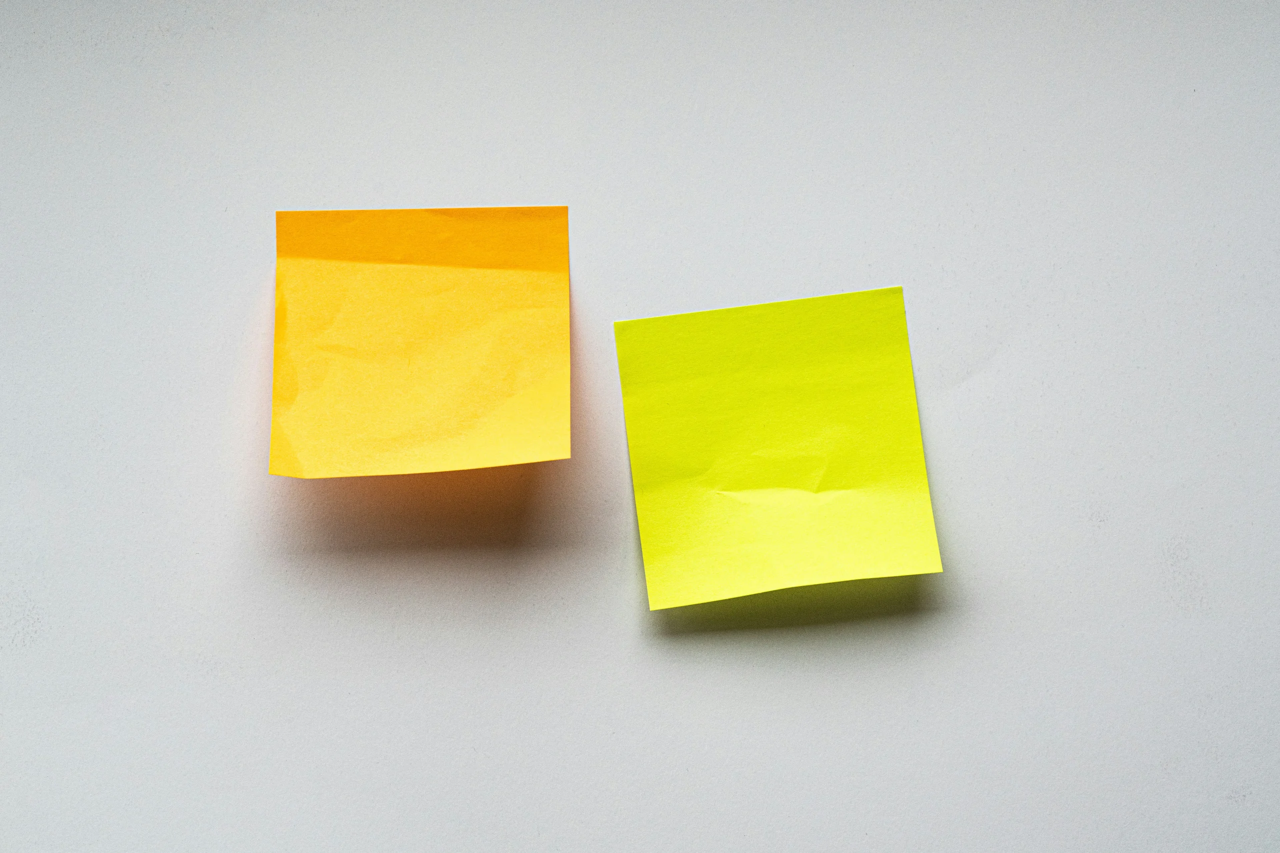 Two colorful sticky notes on a light background, representing extracting key insights and turning long PDFs into small visuals.